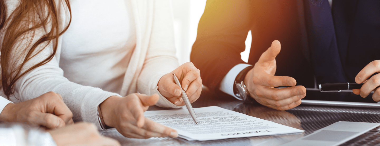 Three people reading an important document